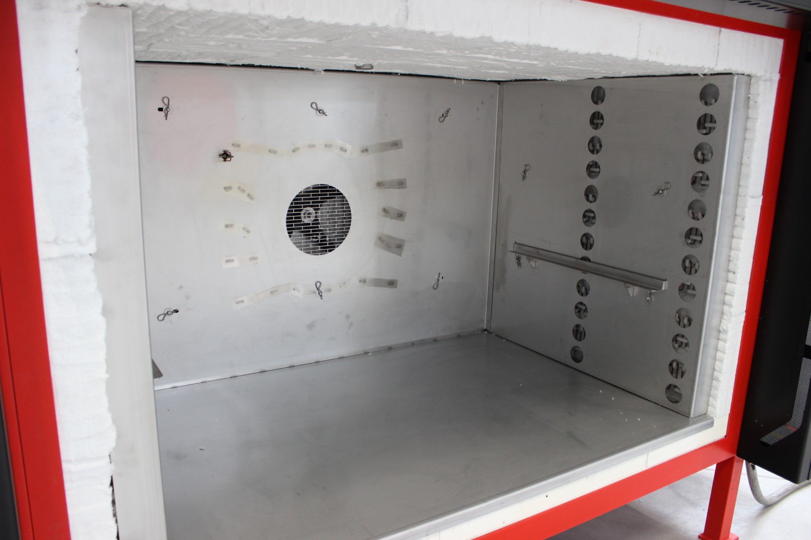 Interior of an industrial furnace showing an opening and channels for forced air circulation